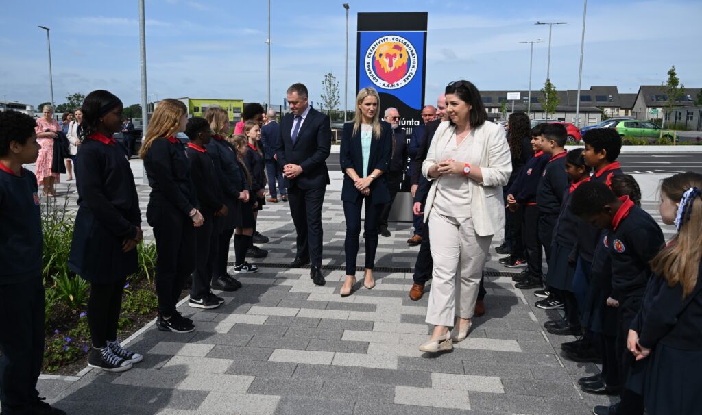 Minister Helen McEntee TD walks with school officials past students forming a guard of honour at Ashbourne CNS